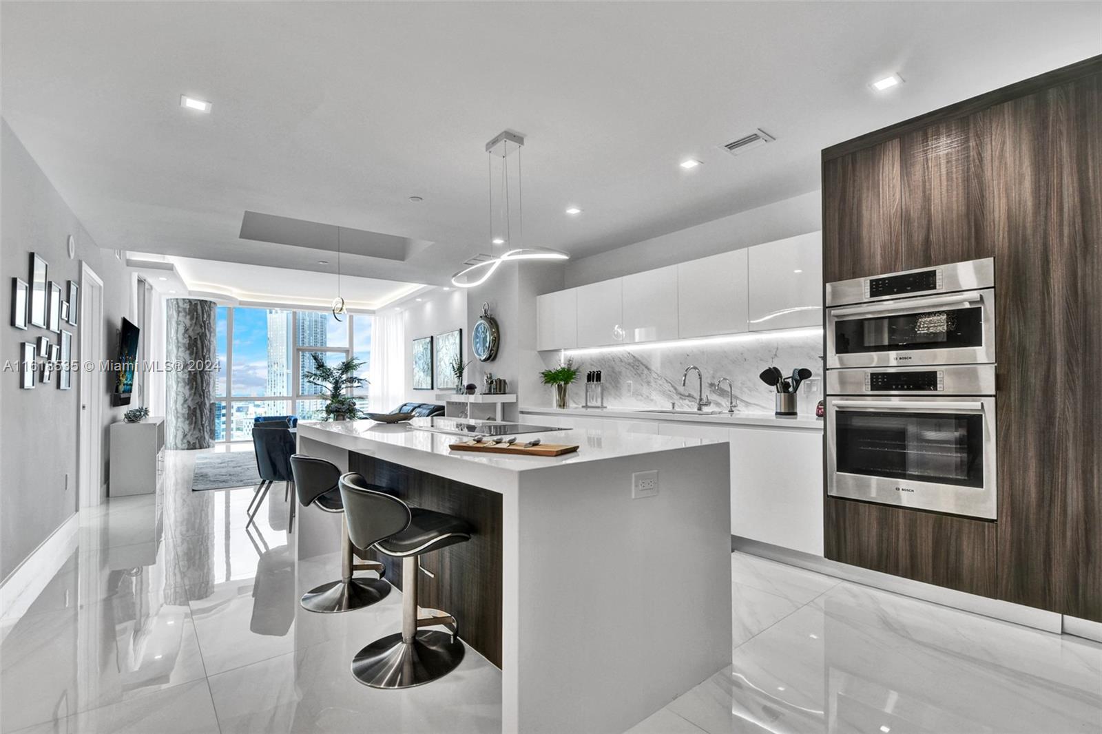 a kitchen with stainless steel appliances kitchen island granite countertop a sink and cabinets