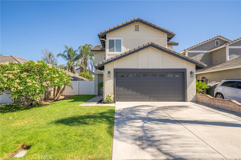 a front view of a house with a yard and garage