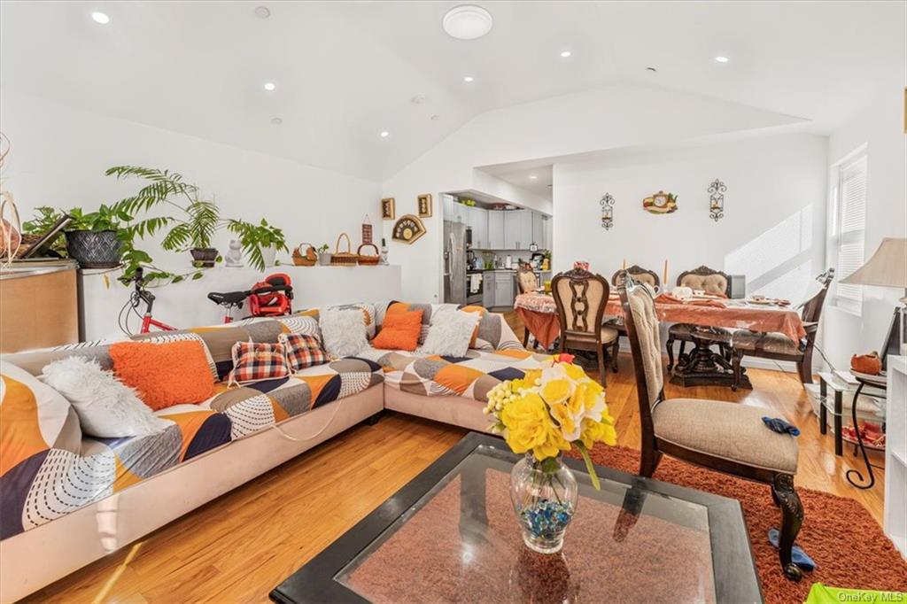 Living room featuring lofted ceiling and hardwood / wood-style floors