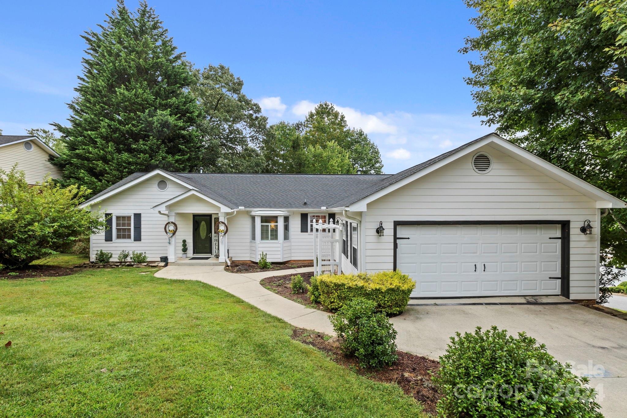 a front view of house with yard and green space