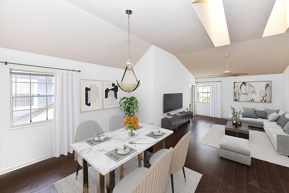 a living room with furniture a flat screen tv and a window