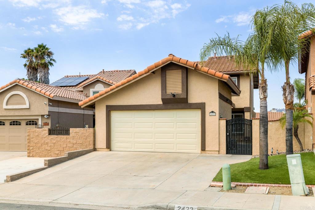 a front view of a house with a yard and garage