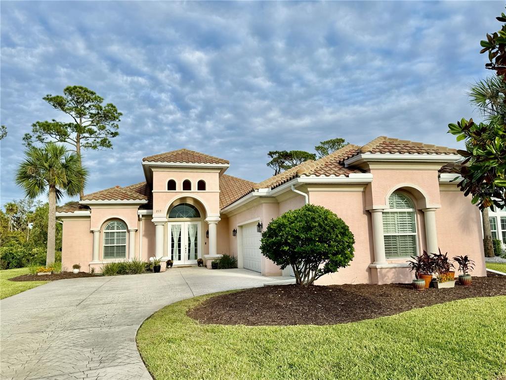 a front view of a house with a garden