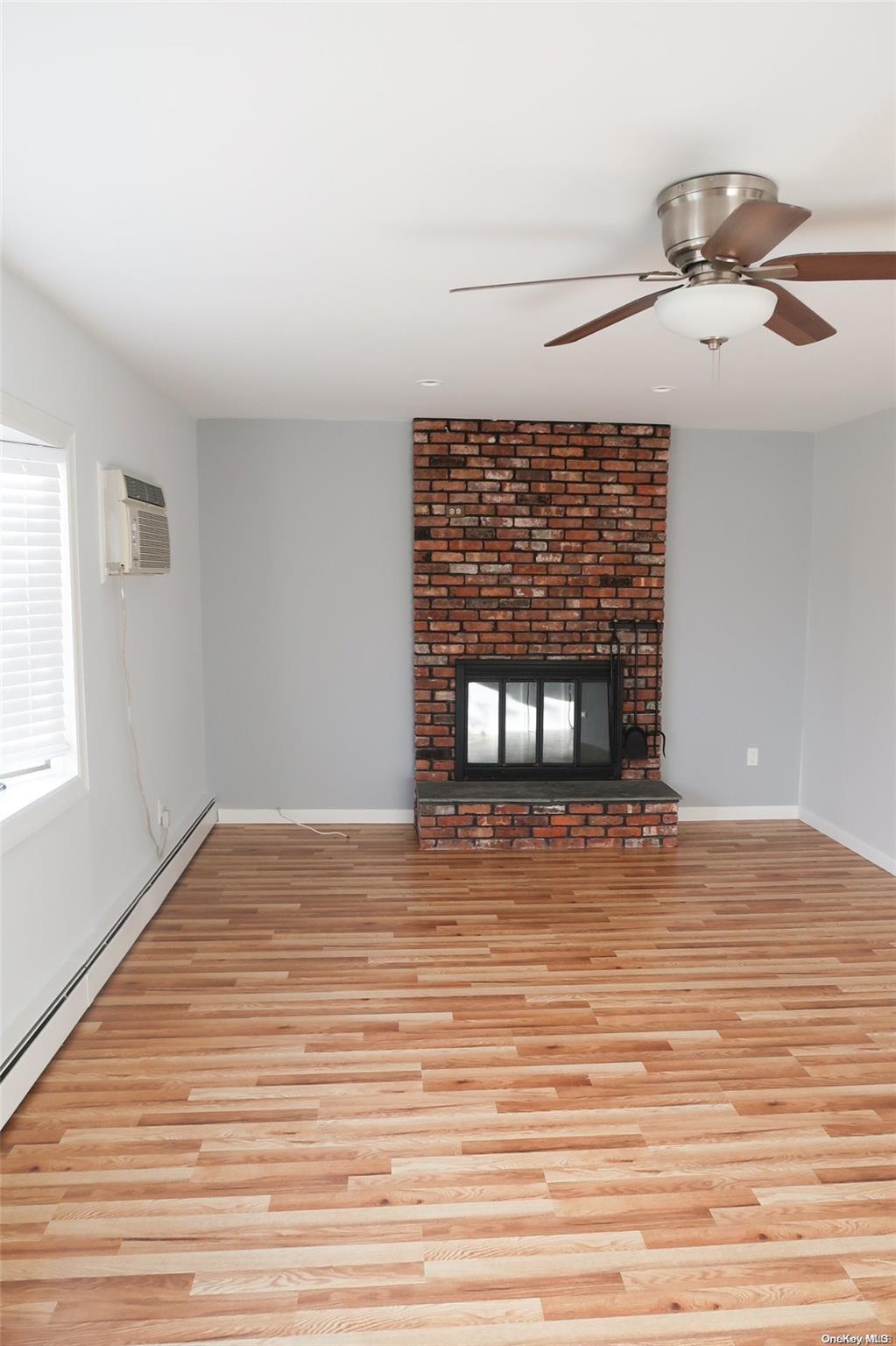 a view of a room with wooden floor