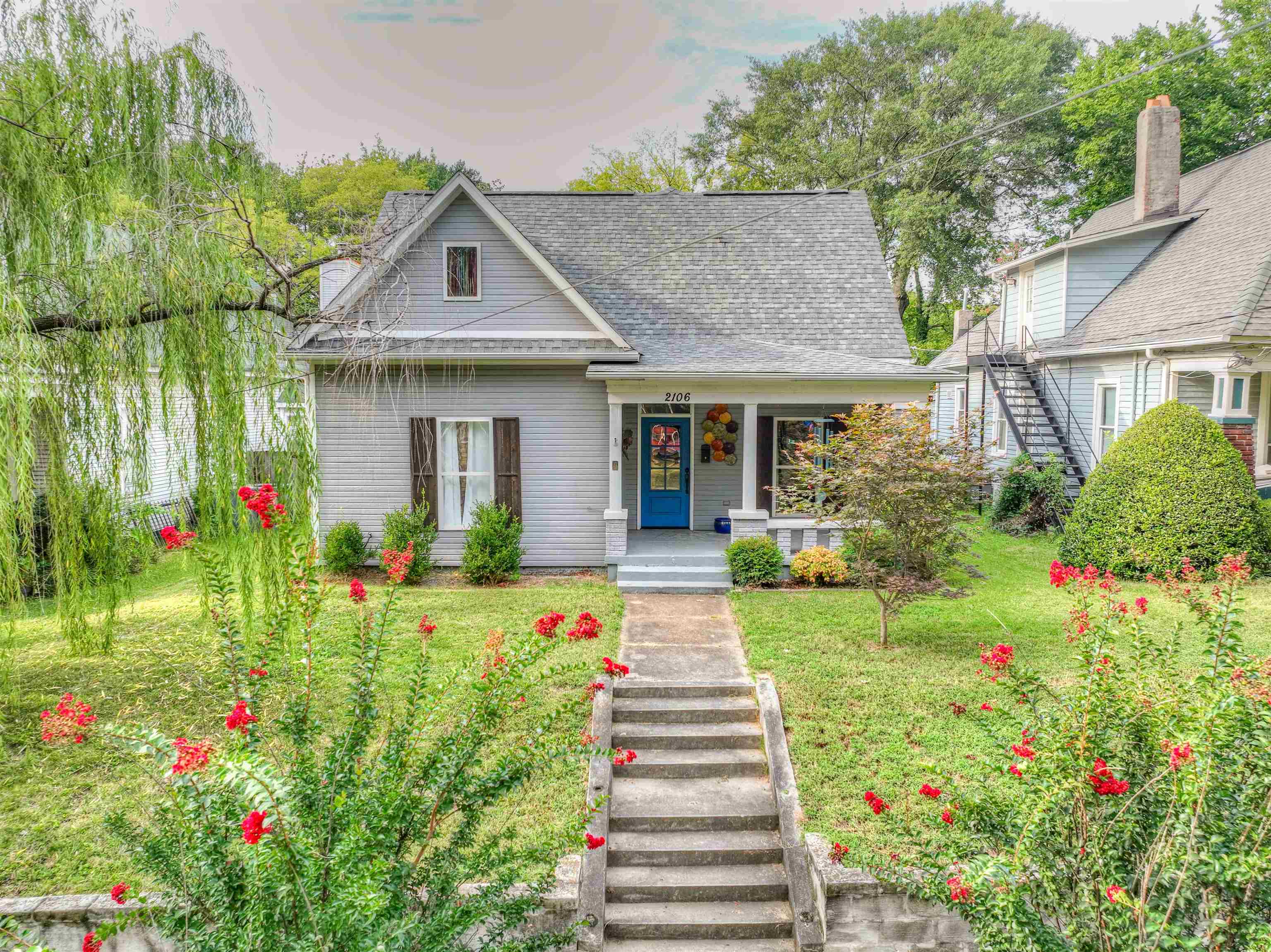 View of front of home with a porch and a front lawn