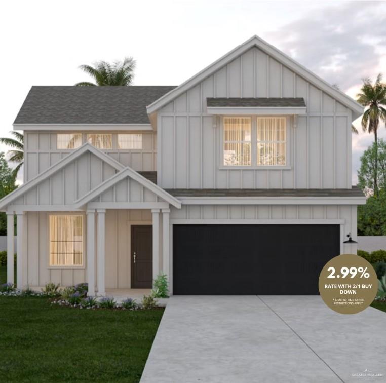 View of front of home with a front yard and a garage