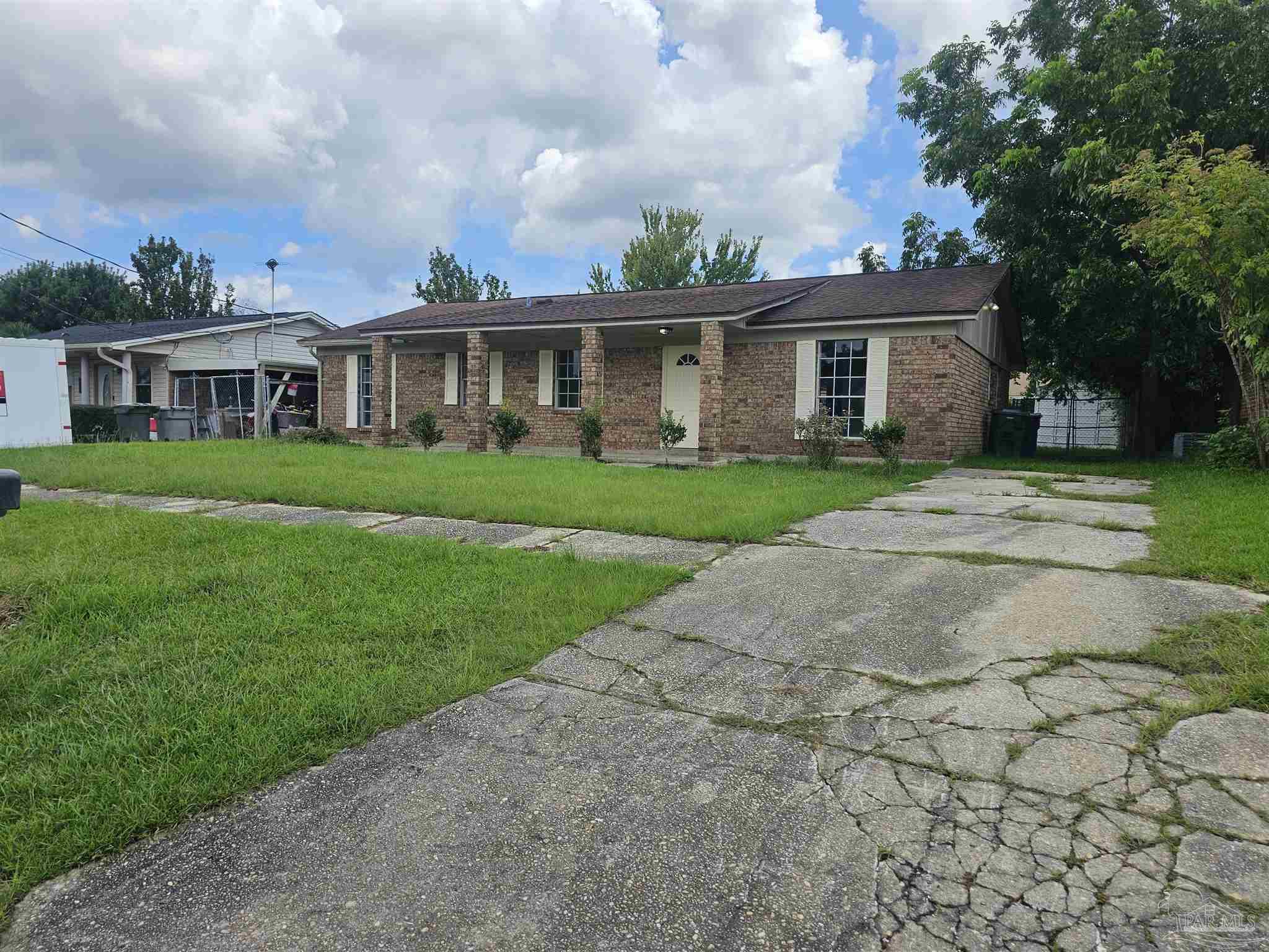 a front view of a house with a garden