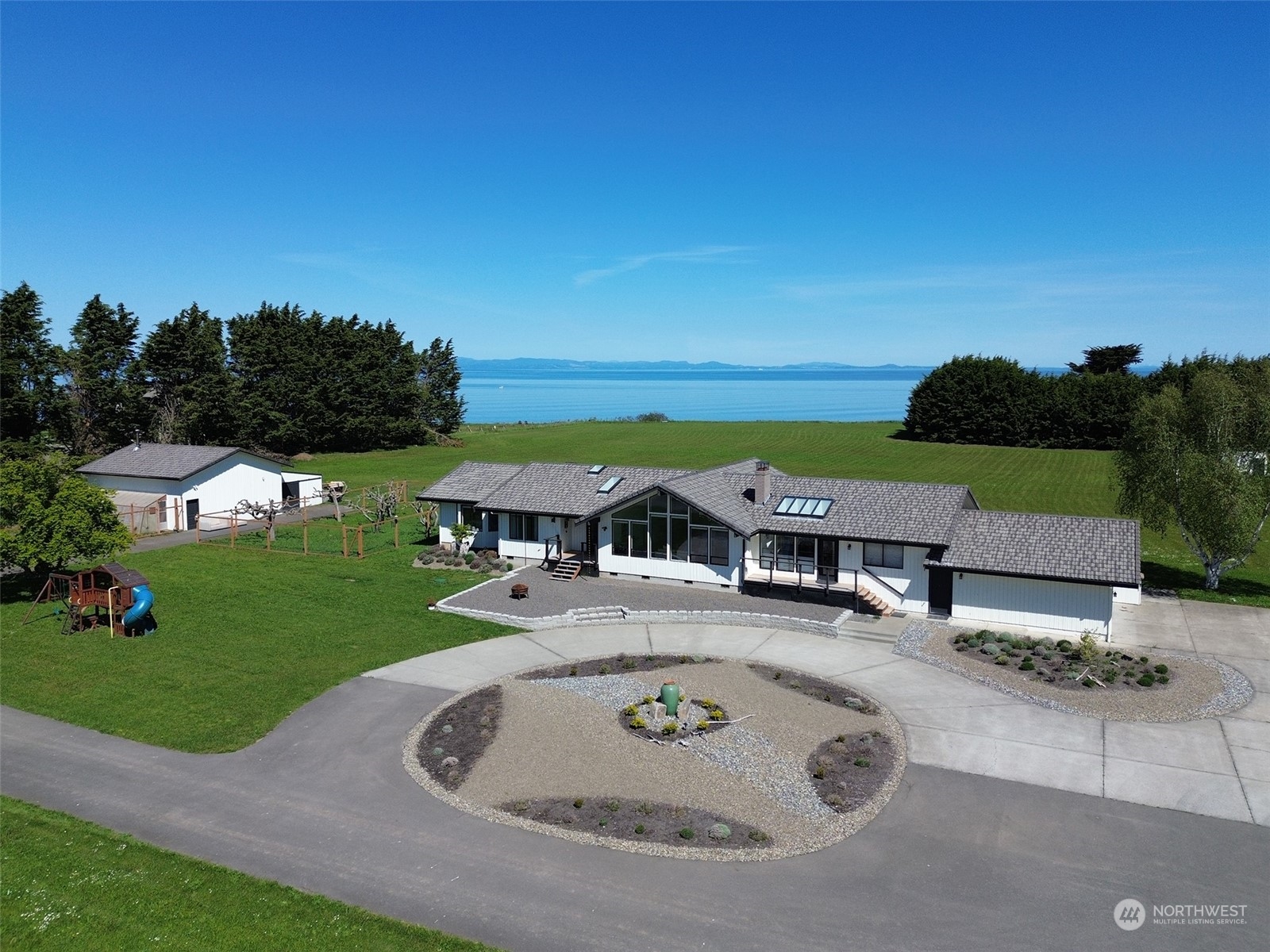 an aerial view of a house with garden space and street view