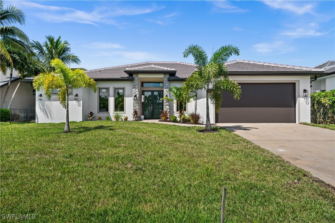 a front view of a house with a yard and garage