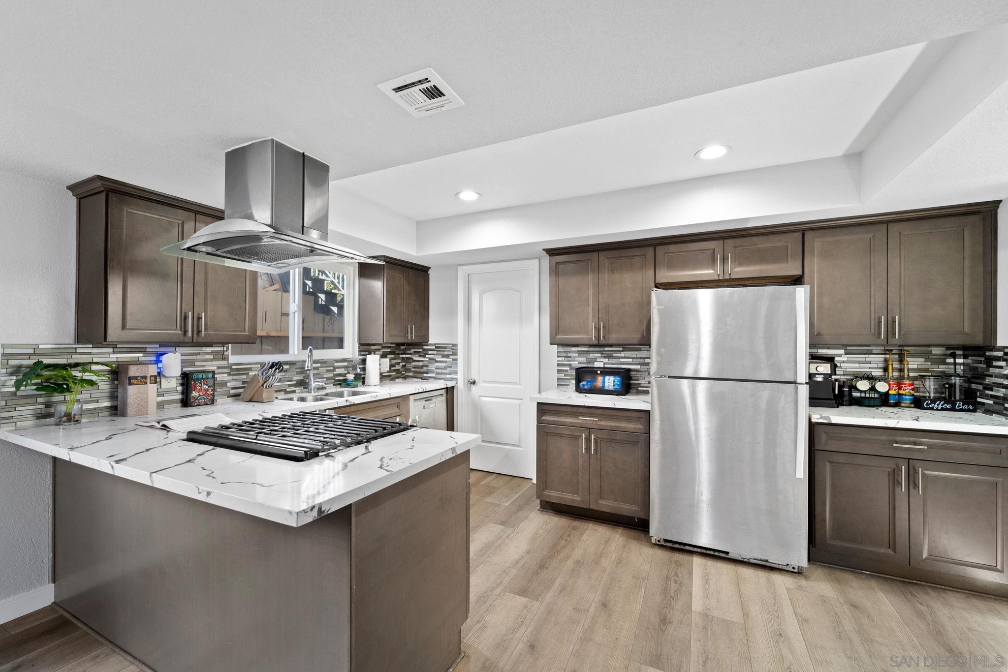 a kitchen with a sink stainless steel appliances and cabinets