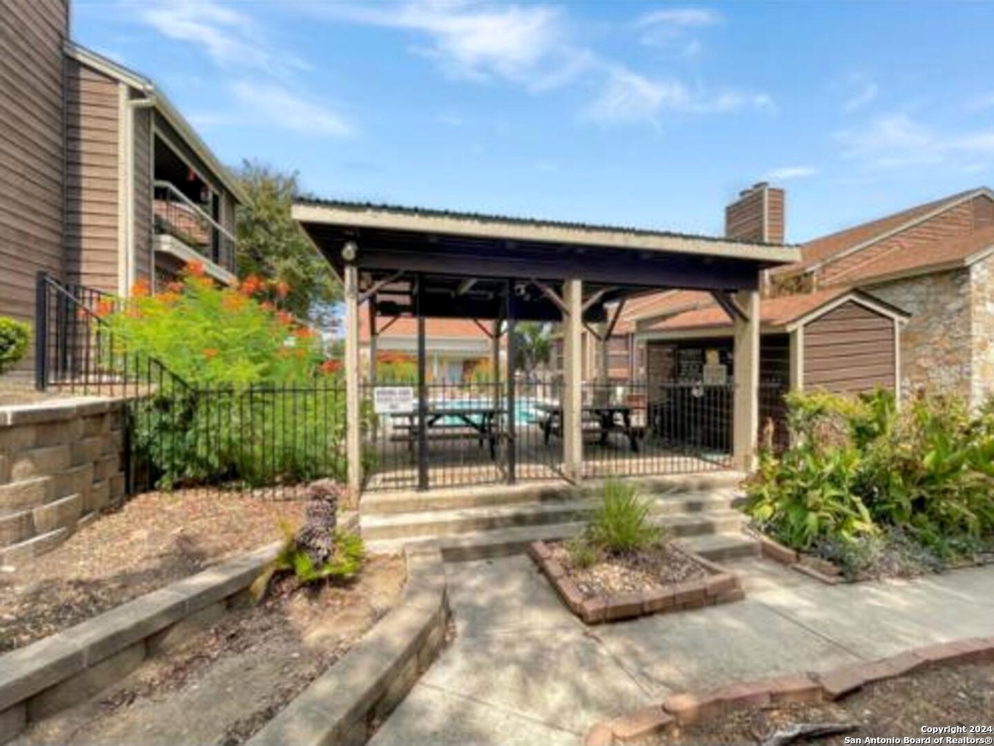 a view of a patio with table and chairs and potted plants