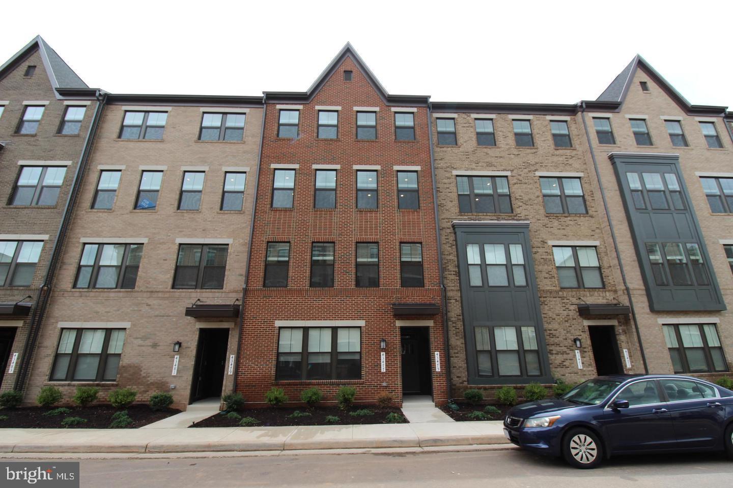 a car parked in front of a brick building