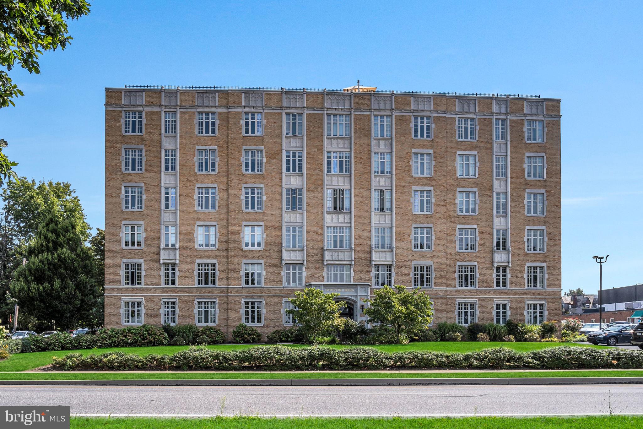 a front view of a building with a yard