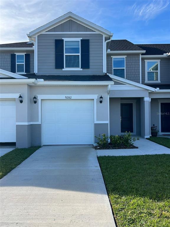 a front view of a house with a yard and garage