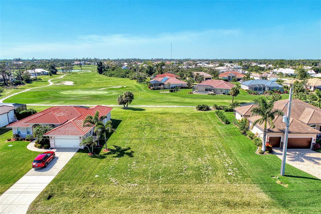 an aerial view of multiple houses with yard