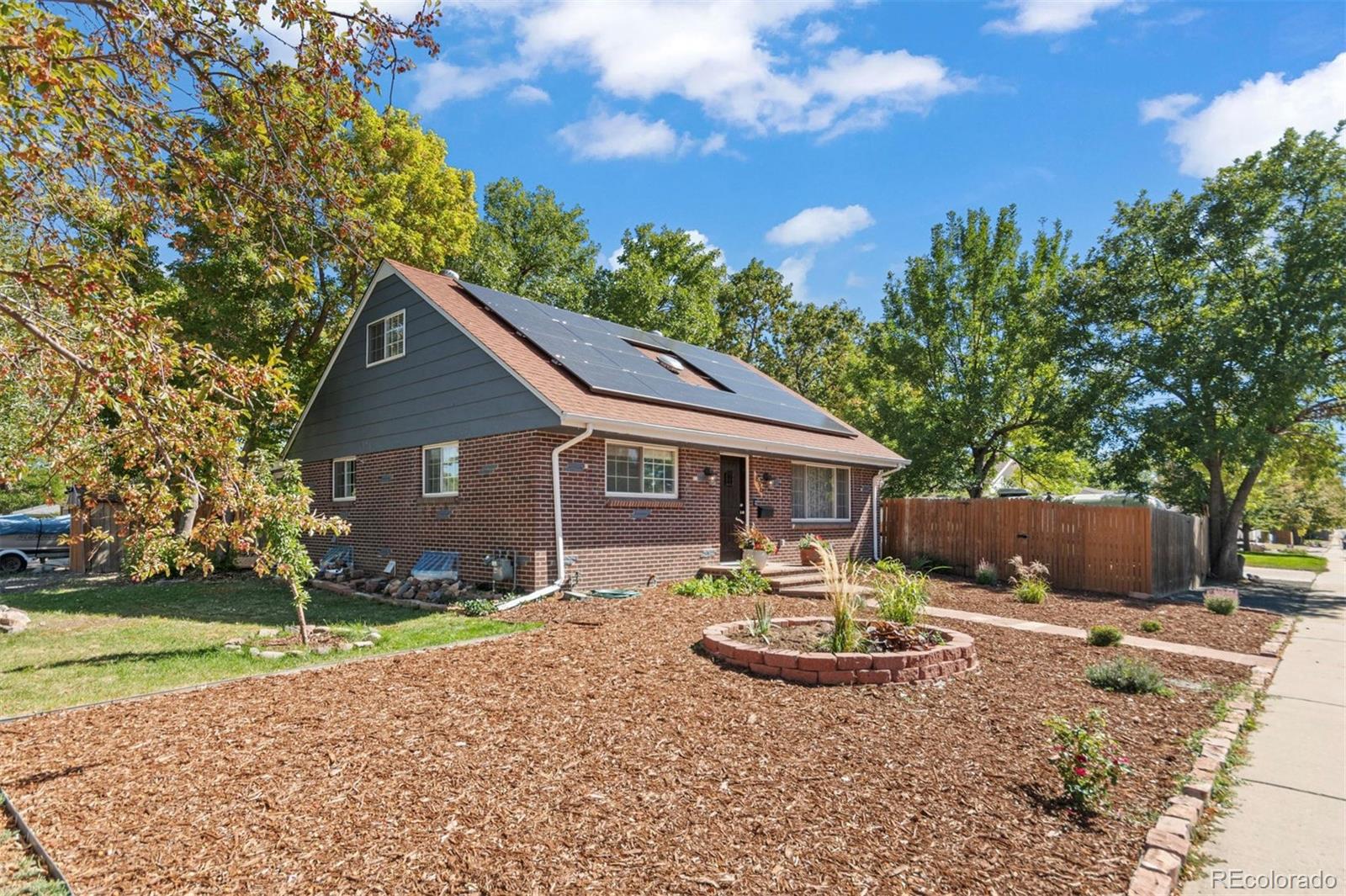 a view of a house with backyard and sitting area