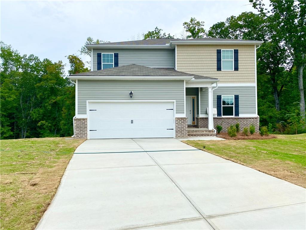 a front view of a house with a yard