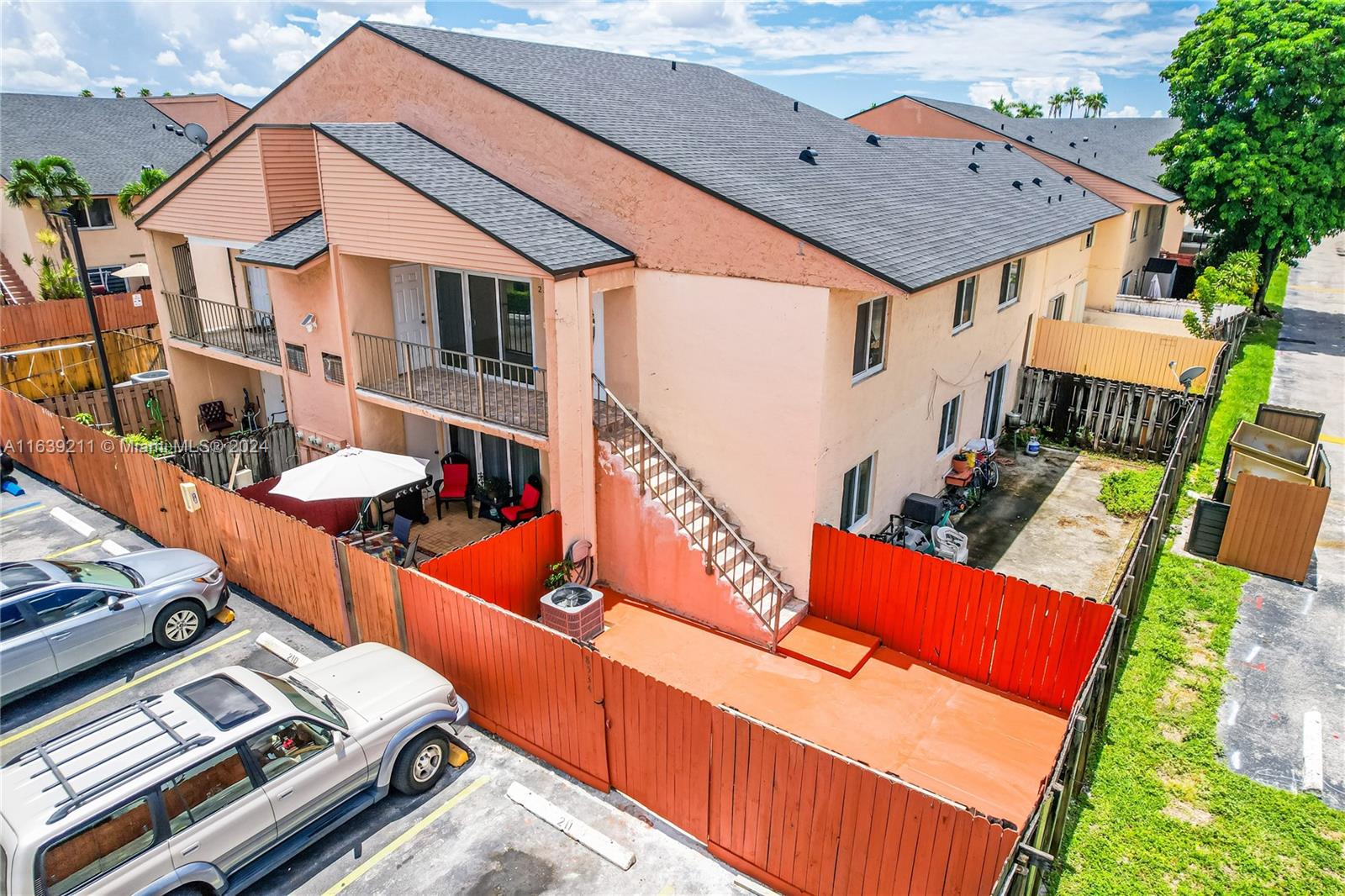 an aerial view of a house with pool and chairs