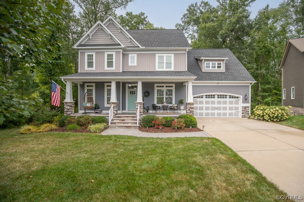 a front view of a house with yard and green space