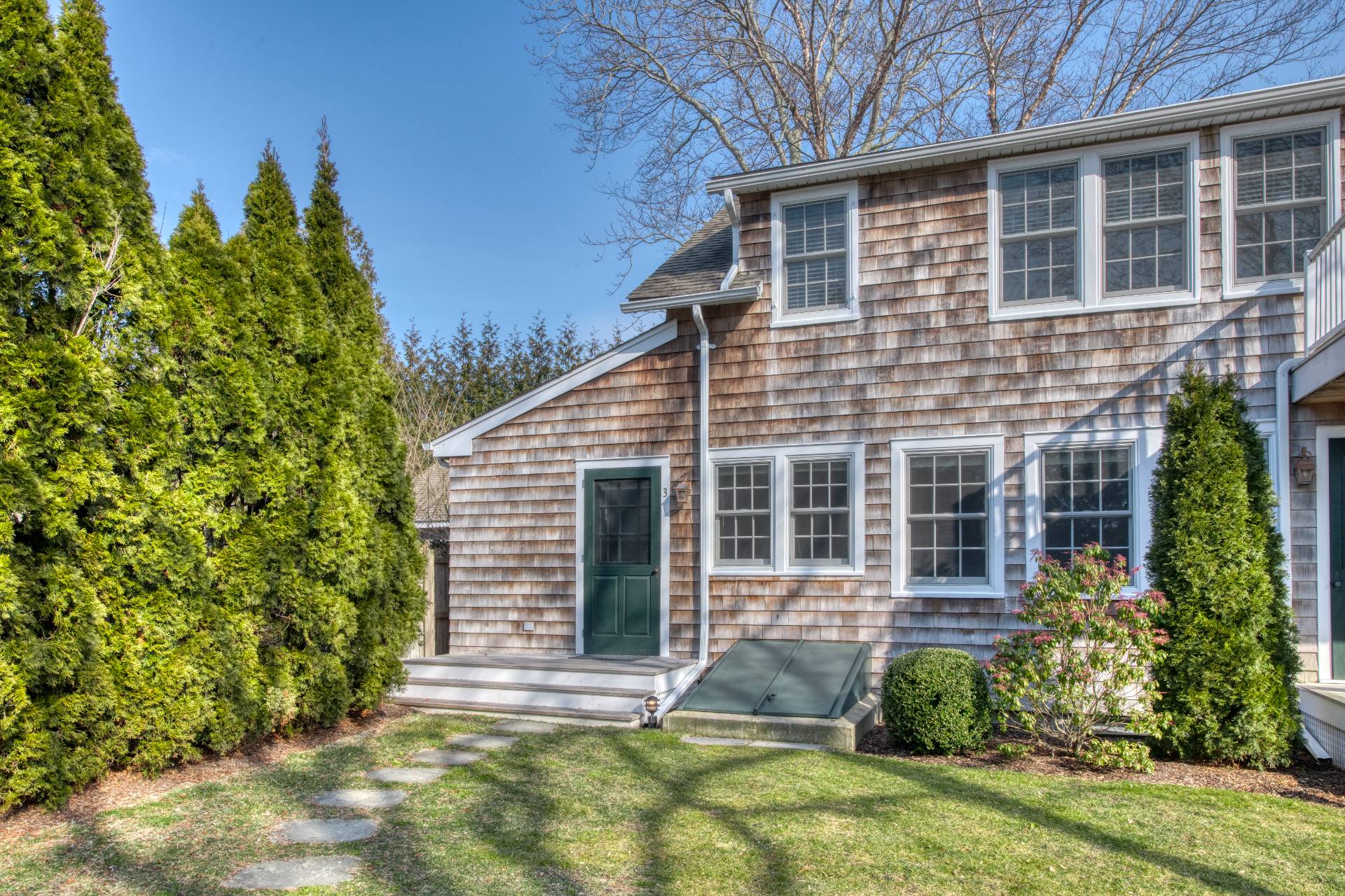 a view of house with backyard and garden