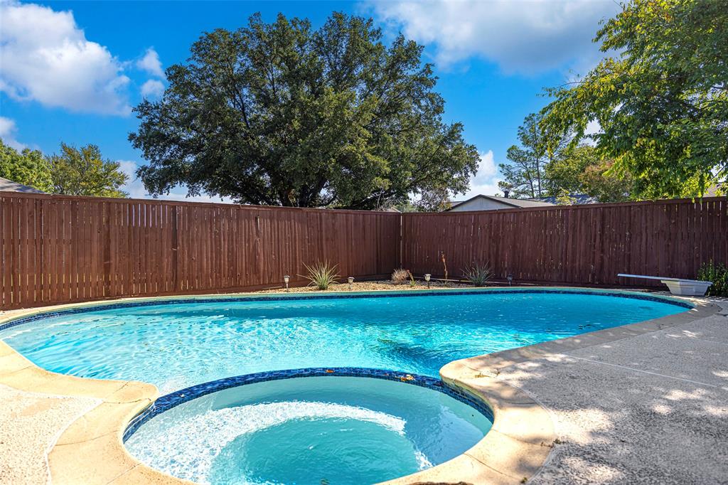 a view of a backyard with swimming pool