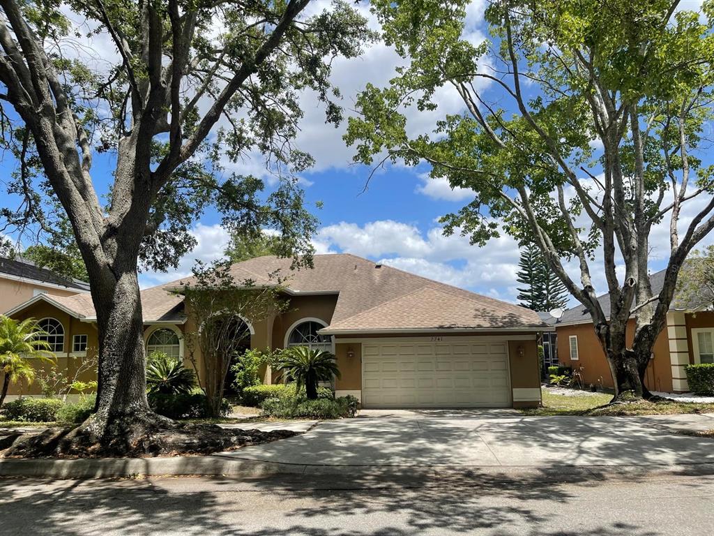 a view of a house with large trees and a tree