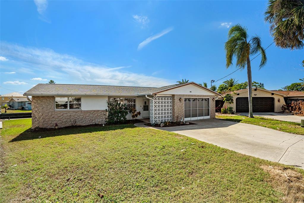 a front view of a house with yard and garage