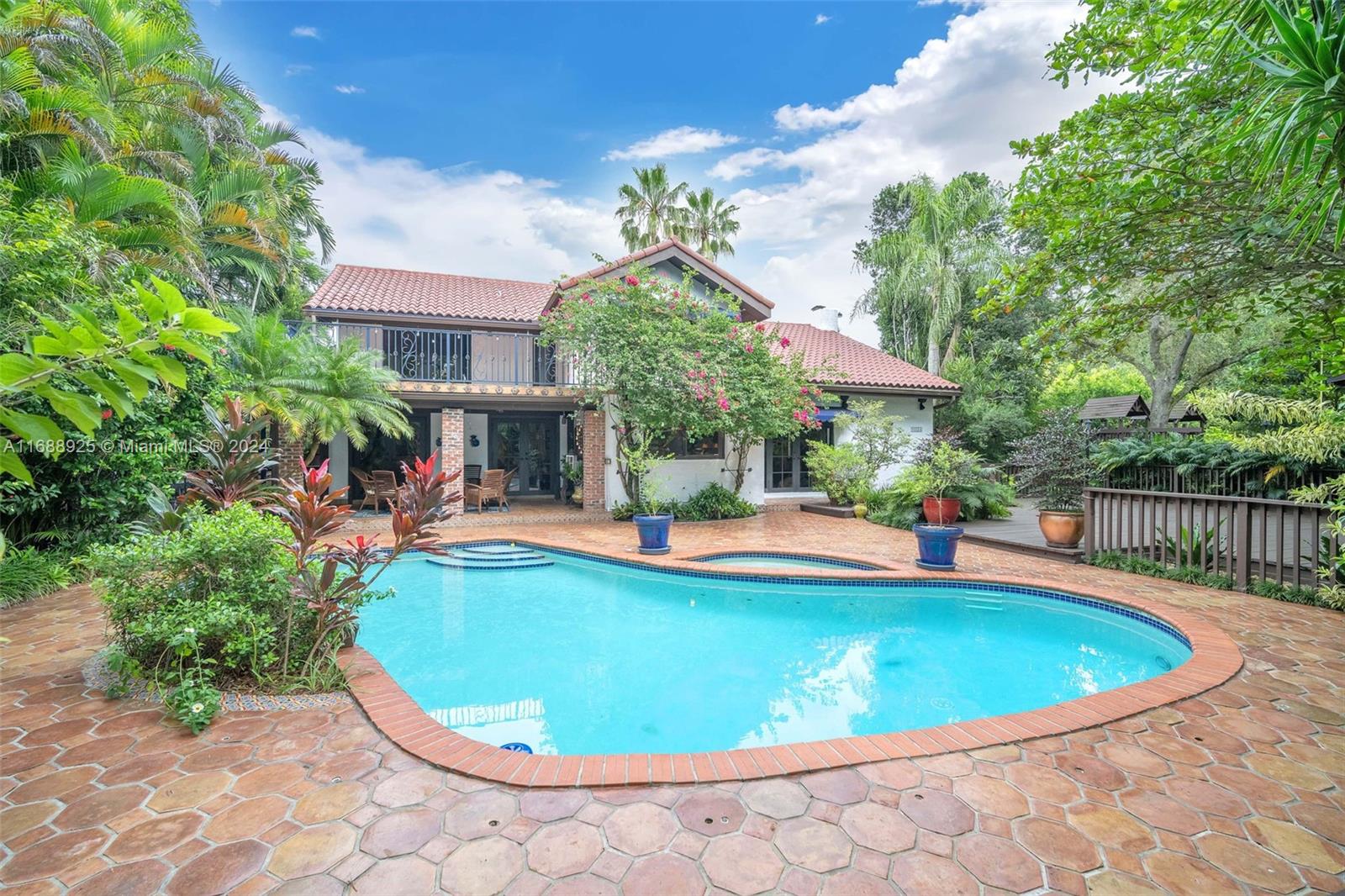 a view of a house with swimming pool and sitting area