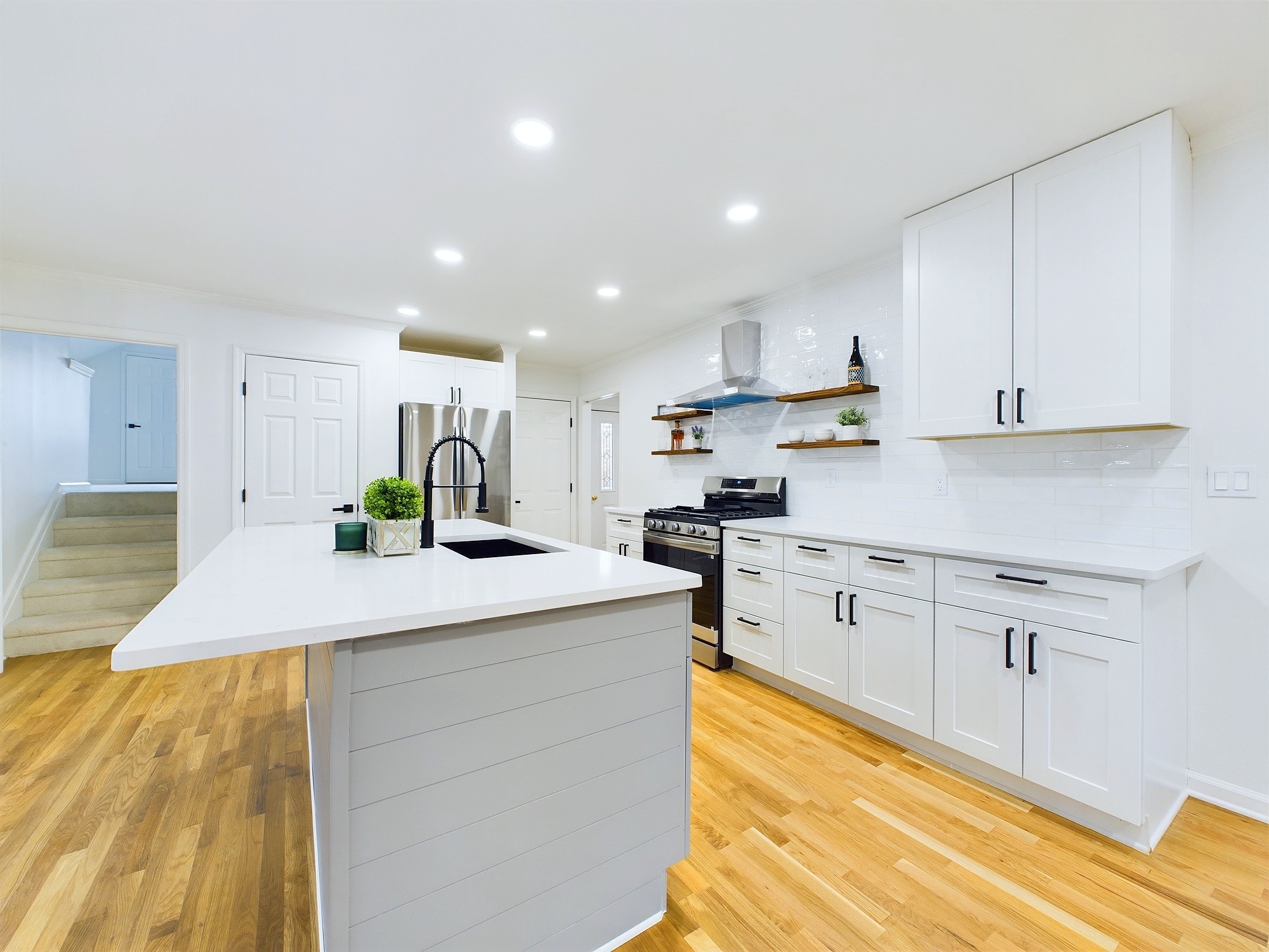 a kitchen with stainless steel appliances granite countertop a sink and cabinets