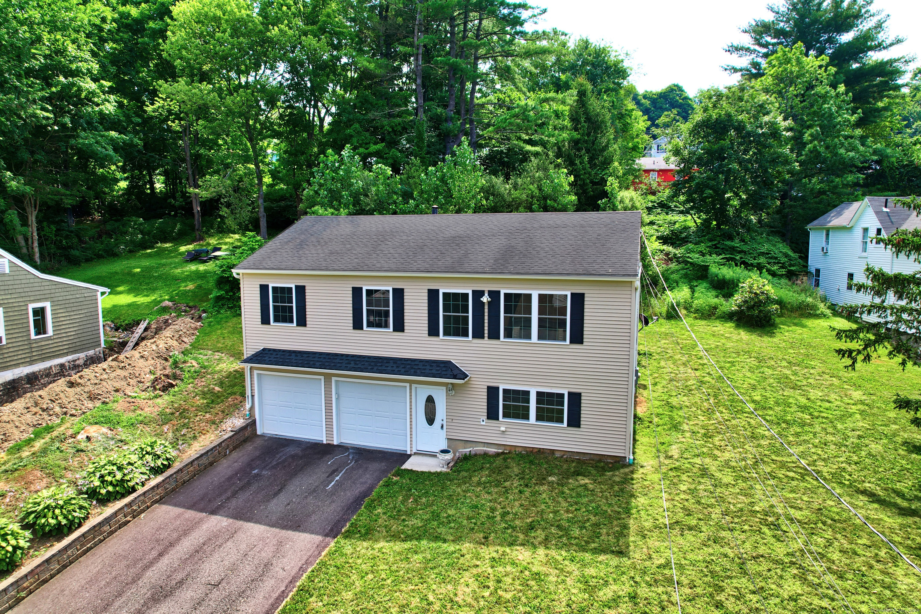 a aerial view of a house next to a yard