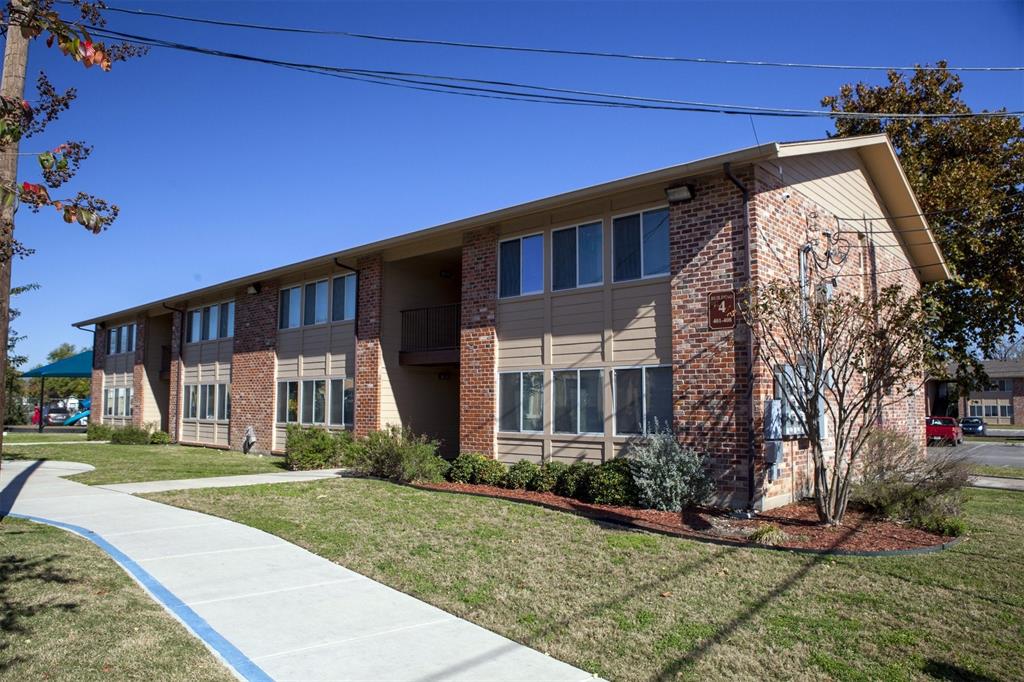 a view of a house with brick walls