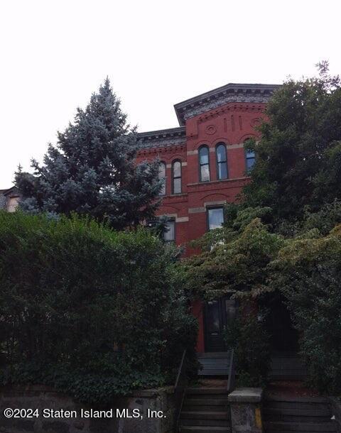 a view of a brick house with a yard