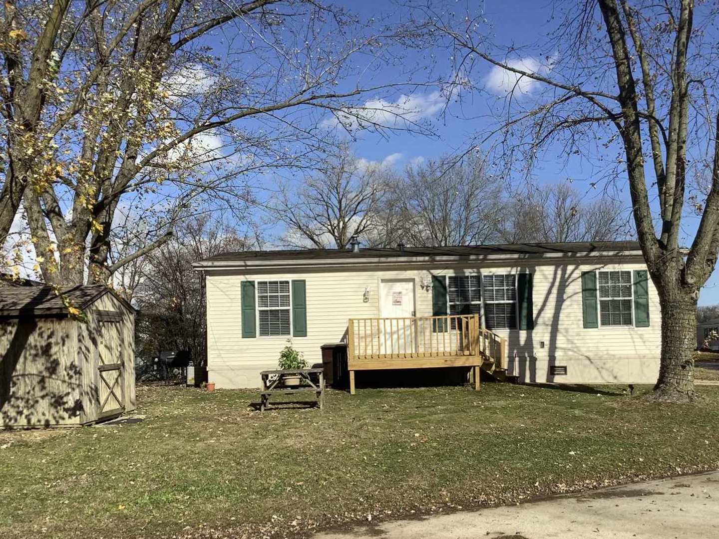 a view of house with backyard space and sitting area