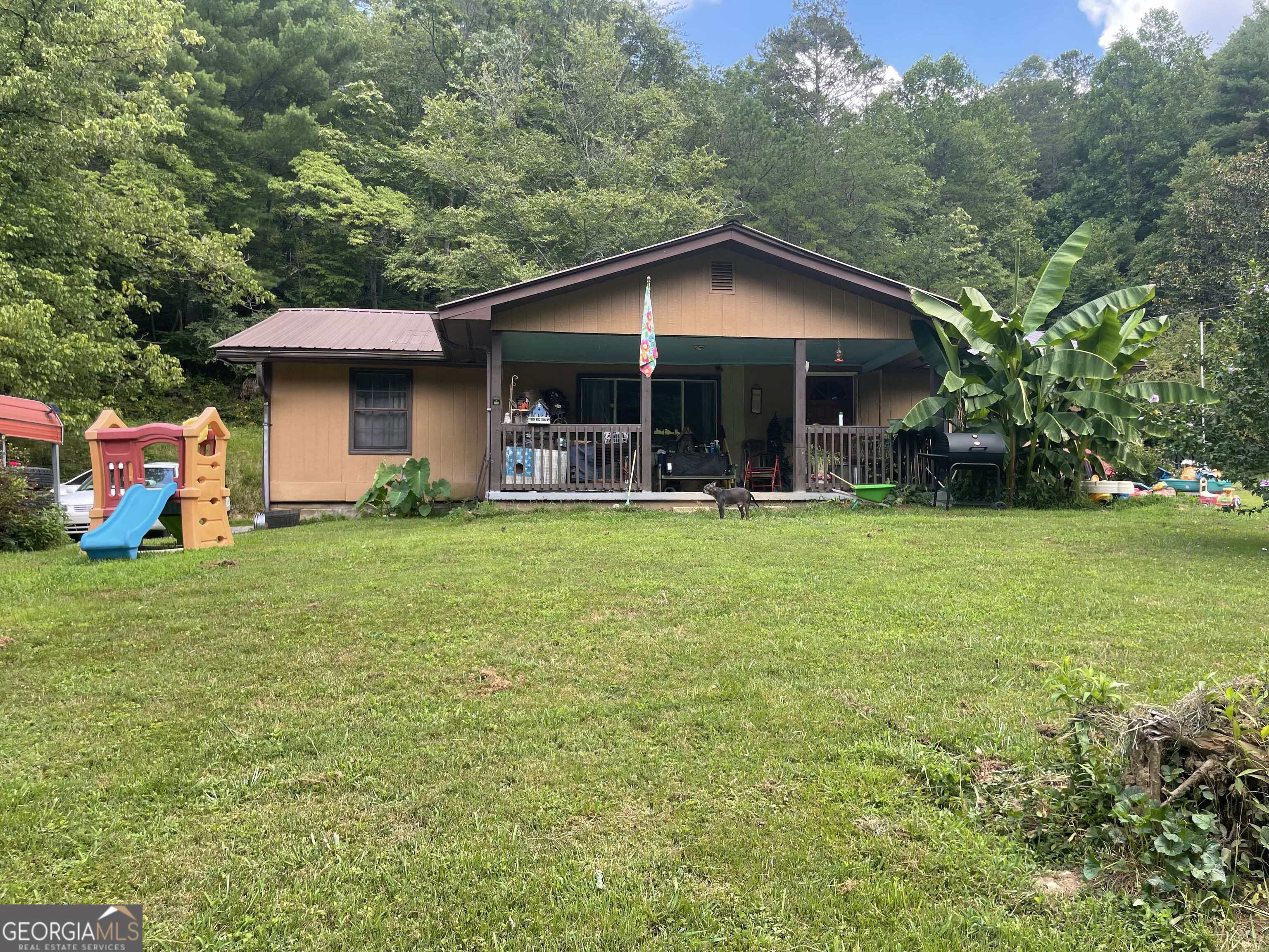 a backyard of a house with yard and trampoline