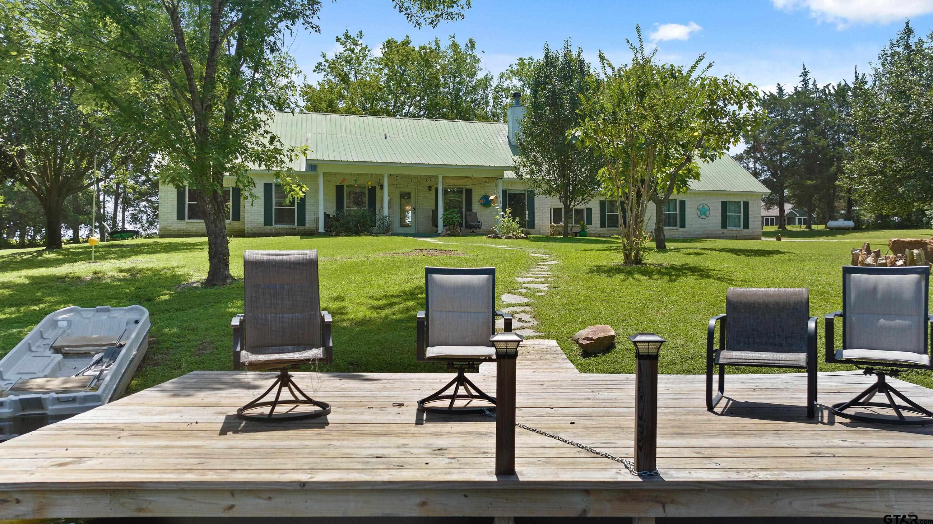 a view of a house with backyard sitting area and garden