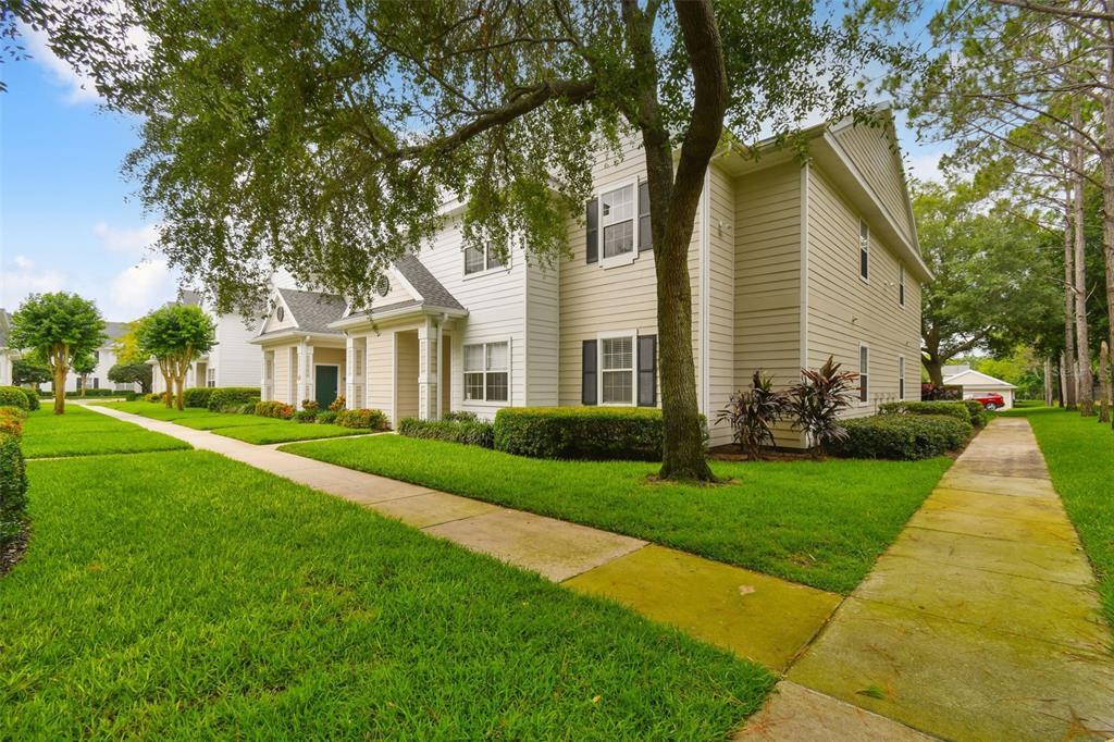 a view of house with a yard