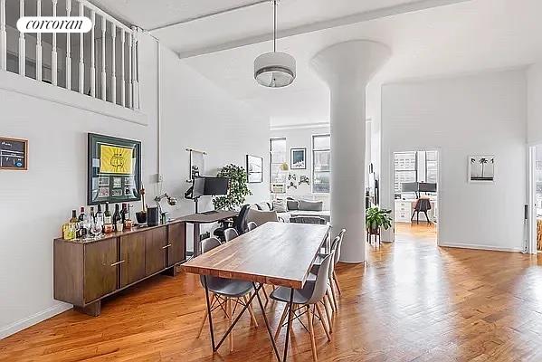 a very nice looking living room with dining room and wooden floor