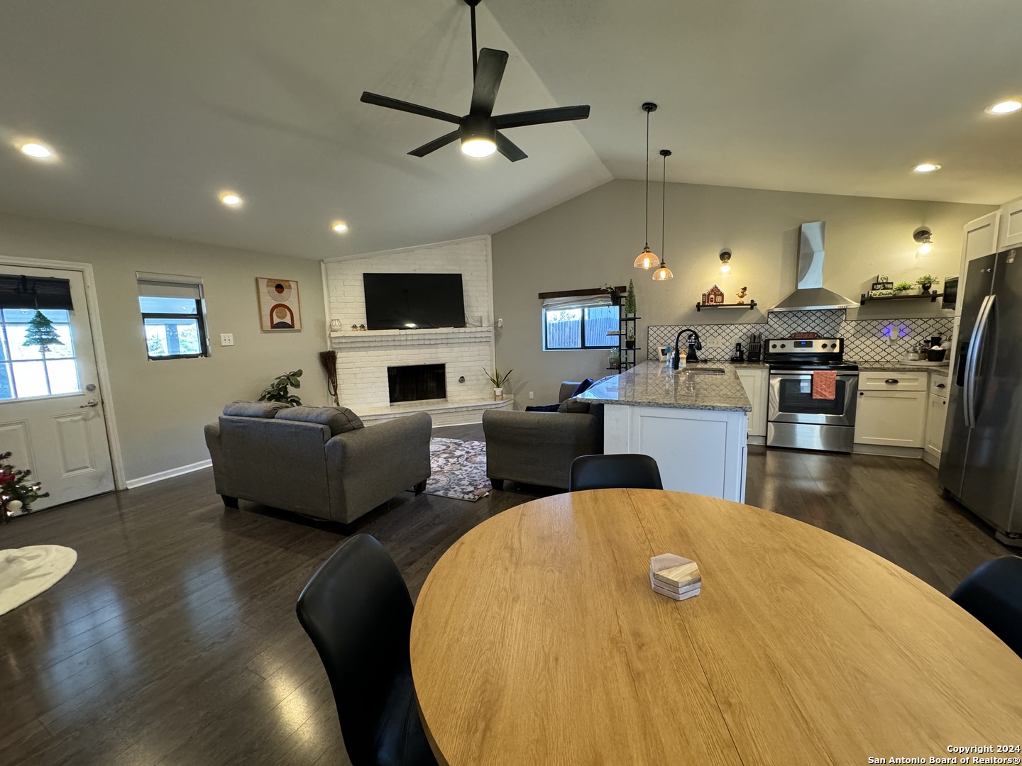 a living room with fireplace furniture and a flat screen tv