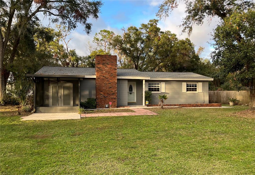 a front view of house with yard and green space