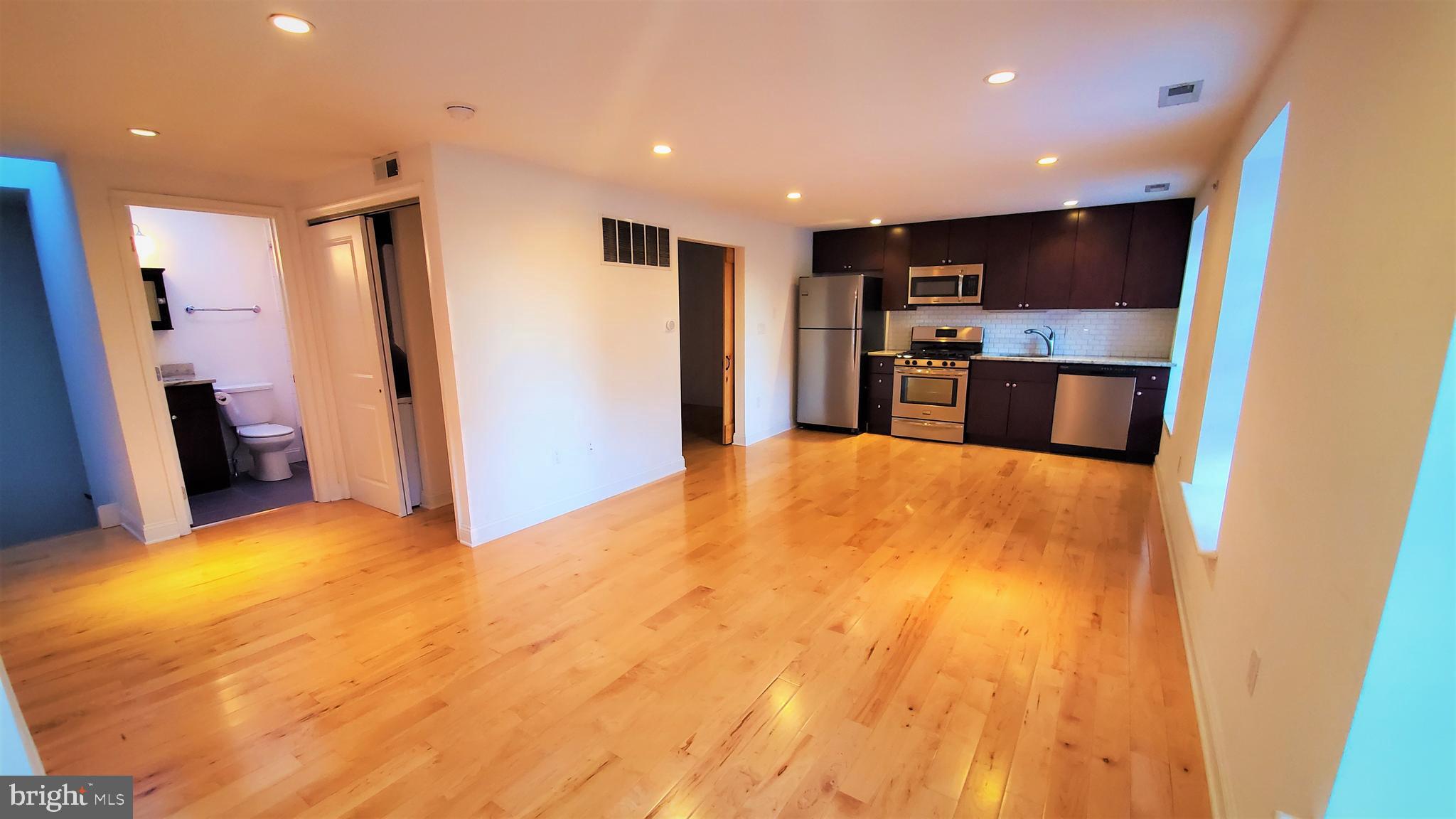 a view of a kitchen with a sink and a refrigerator