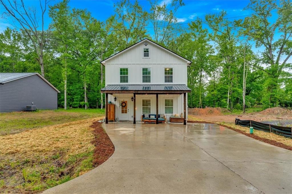 a view of a house with backyard and sitting area