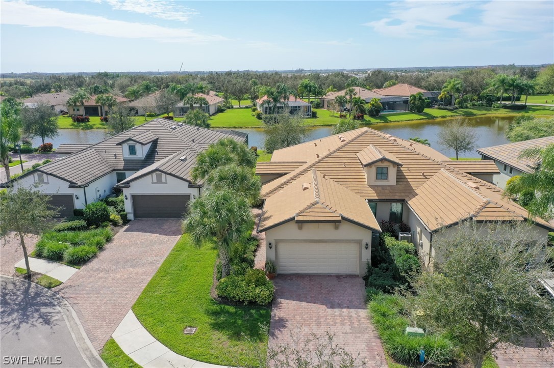 an aerial view of a house with outdoor space and lake view