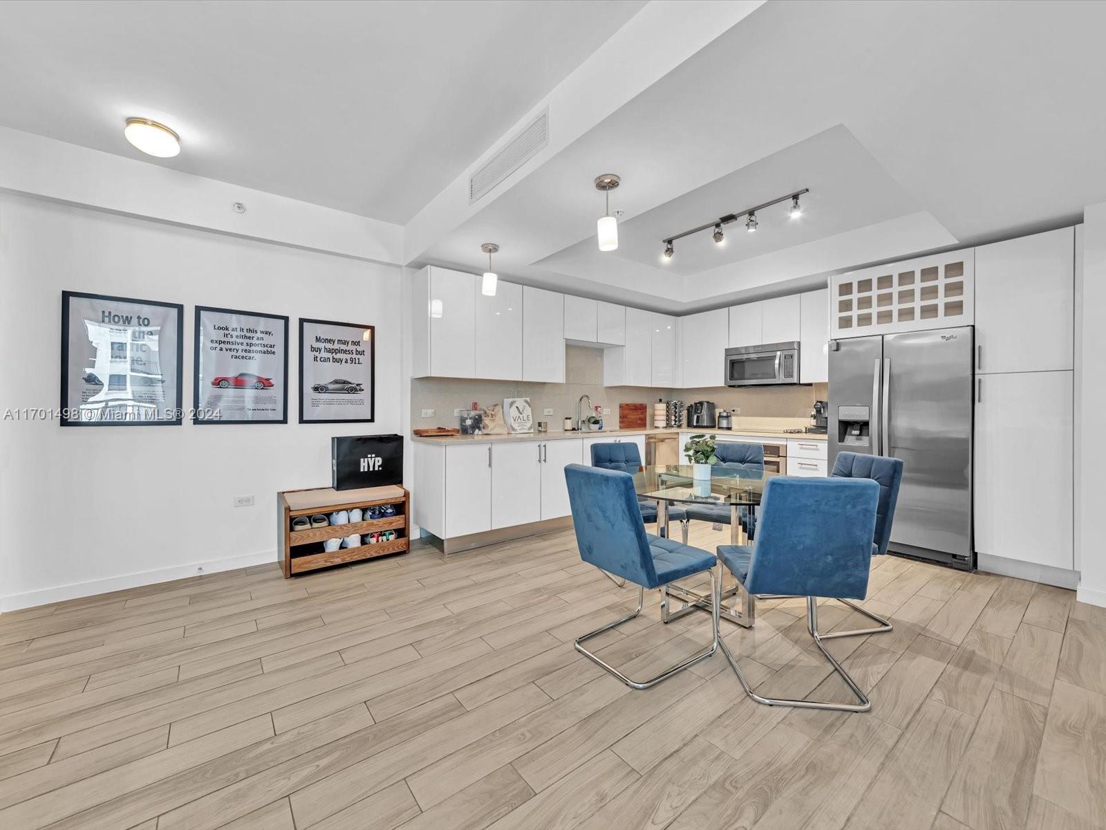 a living room with furniture and kitchen view