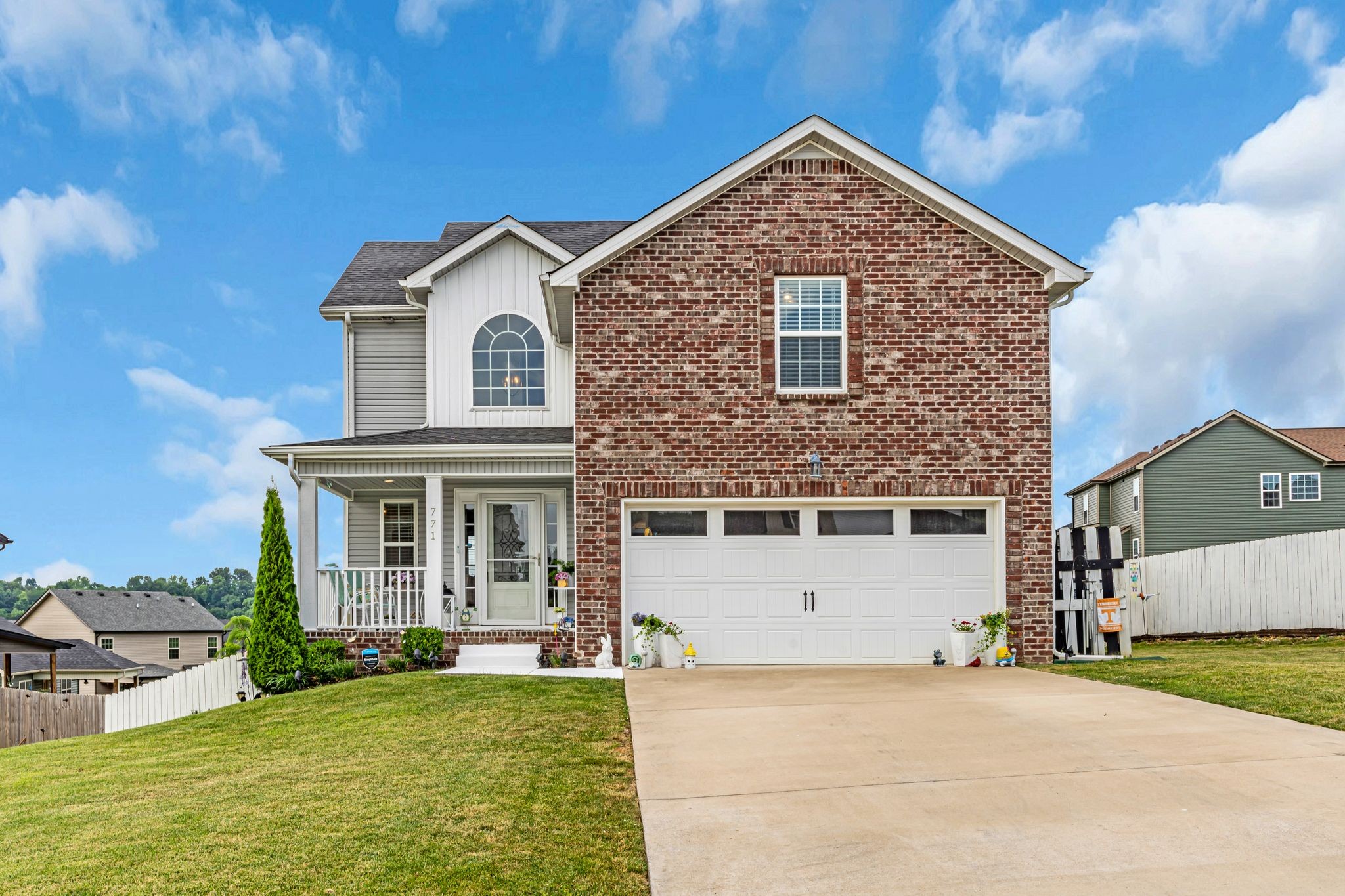 a view of a house with a yard and garage