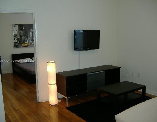 a living room with a flat screen tv and rug