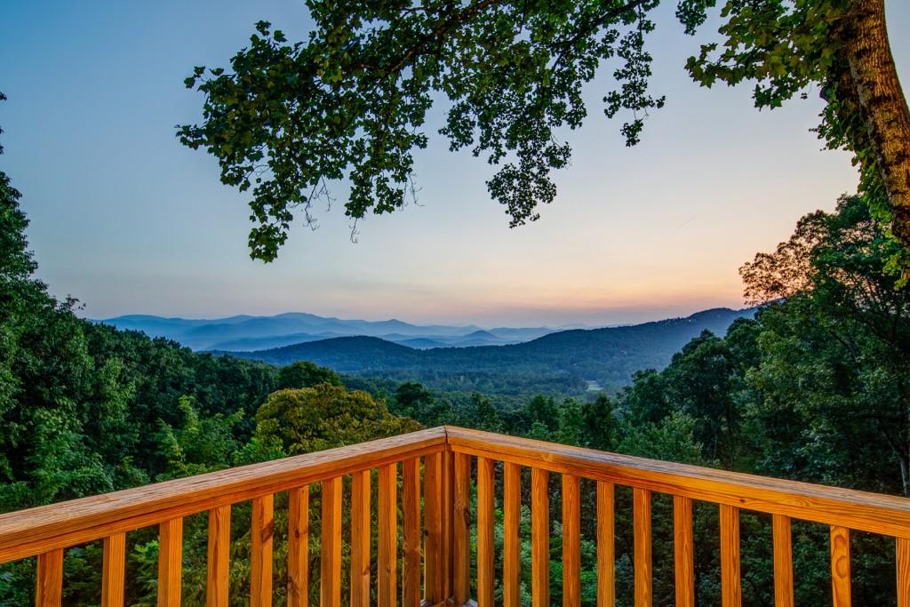 a view of a balcony with a yard