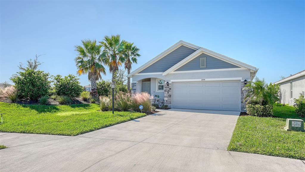 a front view of a house with a yard and garage