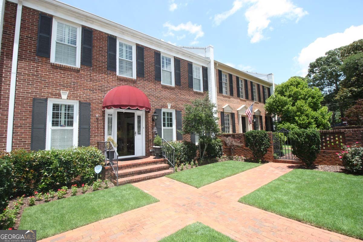 a view of a brick building with a yard