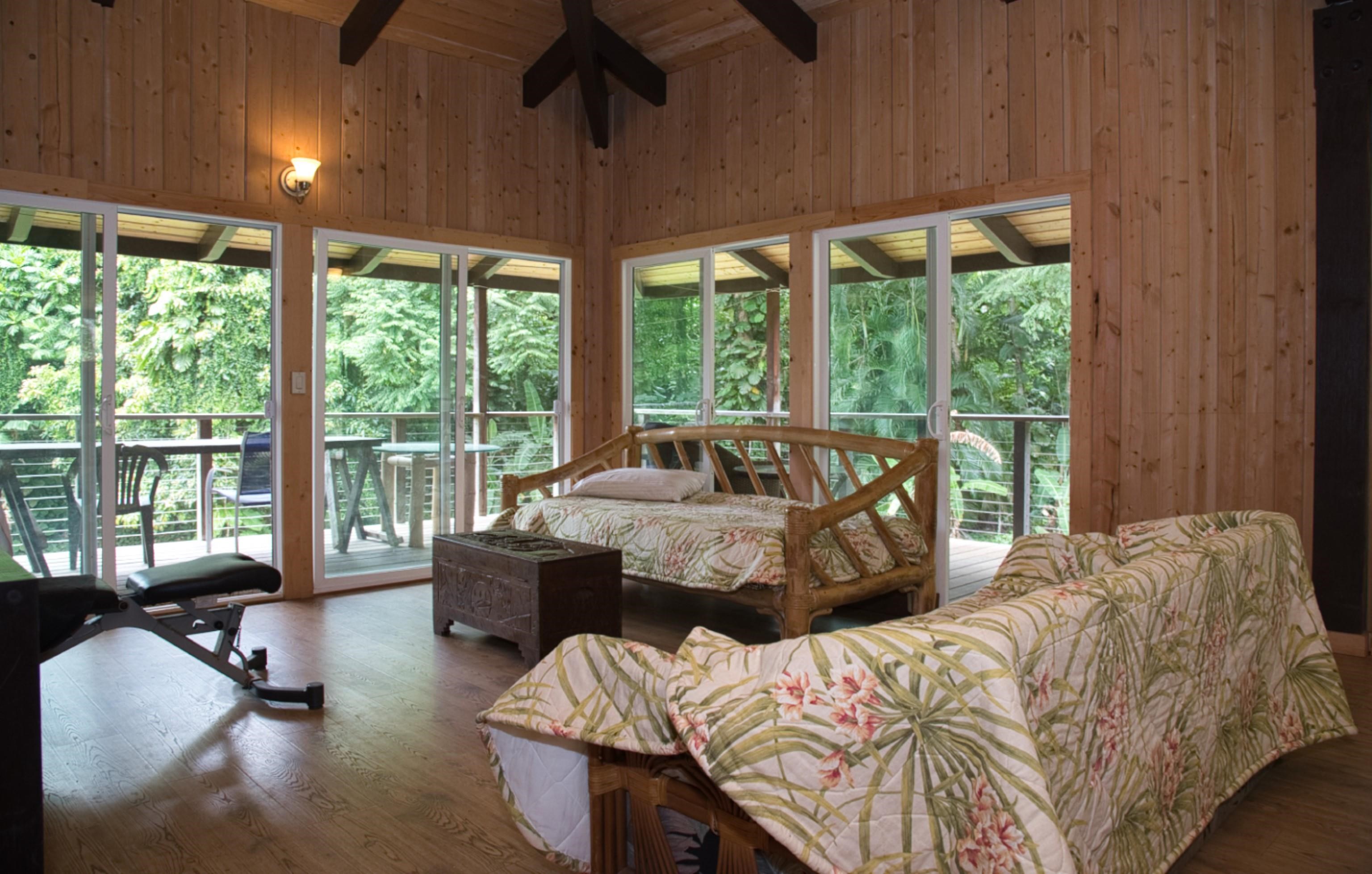 a bedroom with a bed and a large window