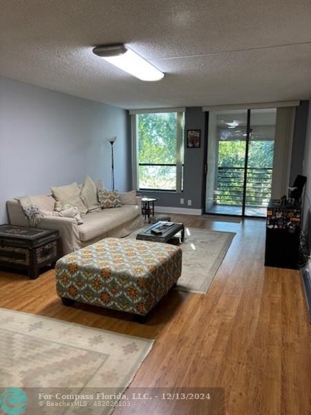 a living room with furniture window and wooden floor